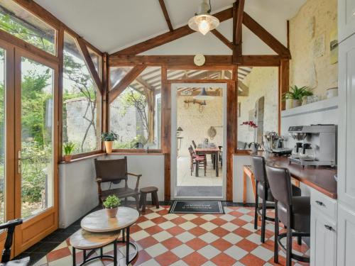 a kitchen and living room with a table and chairs at Maswari en Drapeau in Lusignac