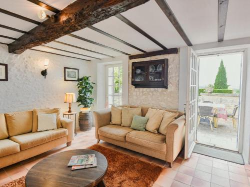 a living room with a couch and a table at Maswari en Drapeau in Lusignac
