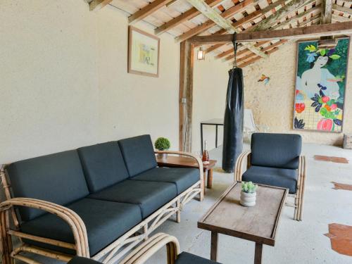 a living room with a couch and two chairs at Maswari en Drapeau in Lusignac