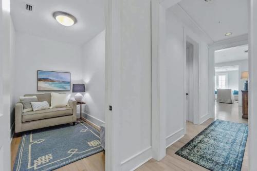 a living room with a couch and a rug at Elegant Three Bedroom Condo Near Rosemary Beach in Rosemary Beach