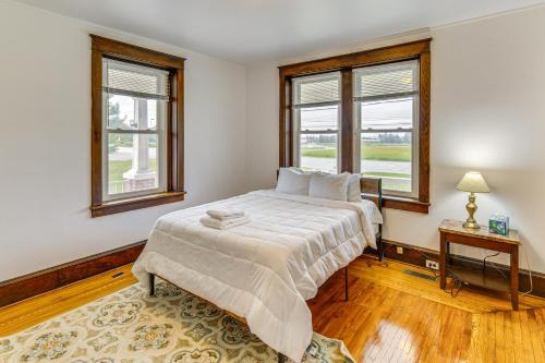 a bedroom with a bed and two windows at Hike, Shop and Explore Apt 1 Mi to Dtwn Lancaster! in Lancaster