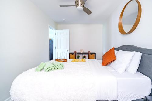 a bedroom with a large white bed and a mirror at Short North Convention Private Parking Pets! in Columbus