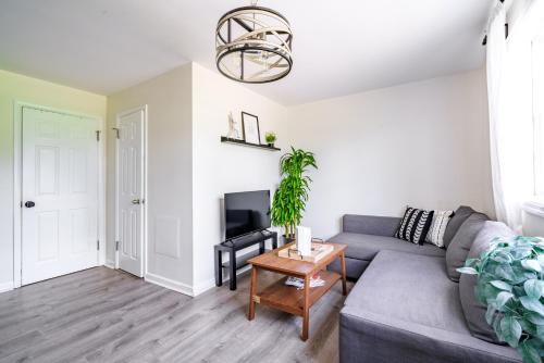 a living room with a gray couch and a table at Short North Convention Private Parking Pets! in Columbus