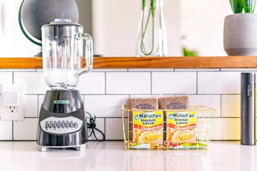 a blender on a counter next to a container of food at Short North Convention Private Parking Pets! in Columbus