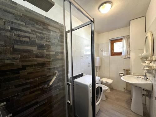 a bathroom with a shower and a toilet and a sink at Appartamento Tasso in Santa Lucia