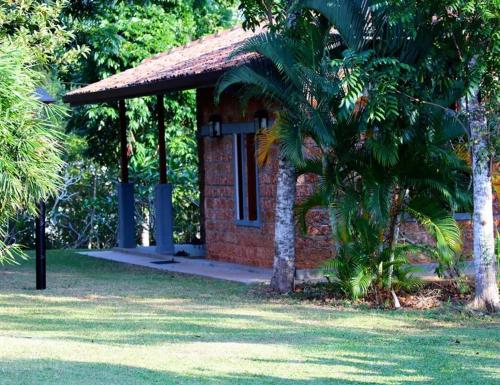 a small brick house with a palm tree in a park at Villa Samithru, Wadduwa in Wadduwa