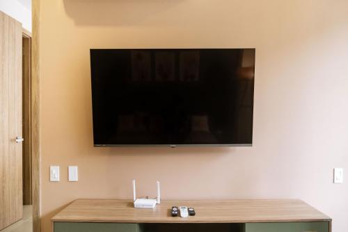 a flat screen tv hanging on a wall at Minimalist 1BR Amazing View in Morros Eos in Cartagena de Indias