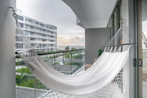 a hammock on the balcony of a building at Minimalist 1BR Amazing View in Morros Eos in Cartagena de Indias