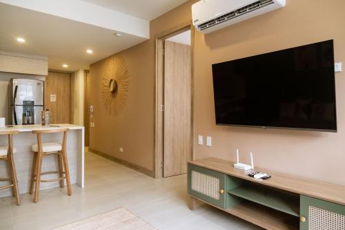 a living room with a flat screen tv on the wall at Minimalist 1BR Amazing View in Morros Eos in Cartagena de Indias