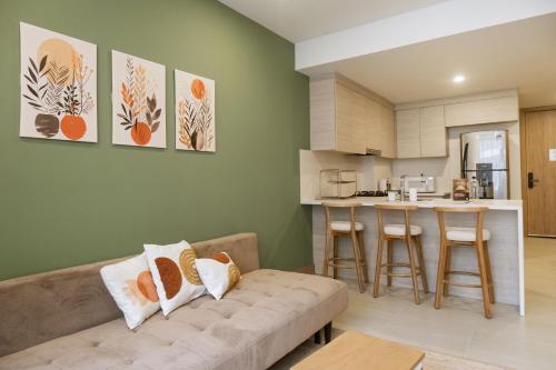a living room with a couch and a kitchen at Minimalist 1BR Amazing View in Morros Eos in Cartagena de Indias