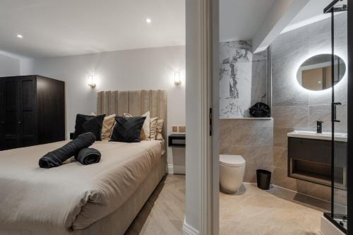 a bedroom with a bed and a bathroom with a sink at Entire Aparthotel Bold St 8 Apartments in Liverpool