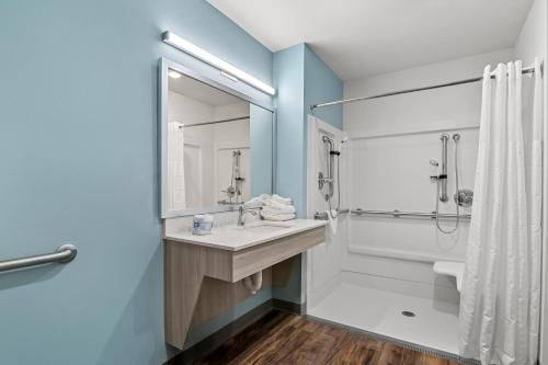 a bathroom with a sink and a shower and a toilet at WoodSpring Suites Newington - Hartford South in Newington