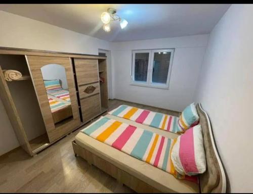 a bedroom with a bed and a dresser at Apartament in Ferizaj