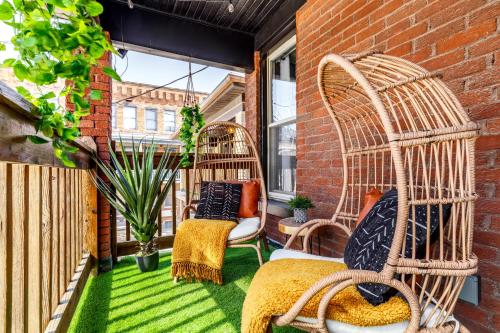 a small balcony with two wicker chairs and a window at Prime Location Top Rated Clean Parking Free! in Columbus