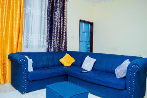 a blue couch with pillows on it in a living room at Frank's Homes in Kwale