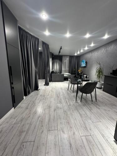 a living room with a couch and a table at Grey Harmony room in Almaty