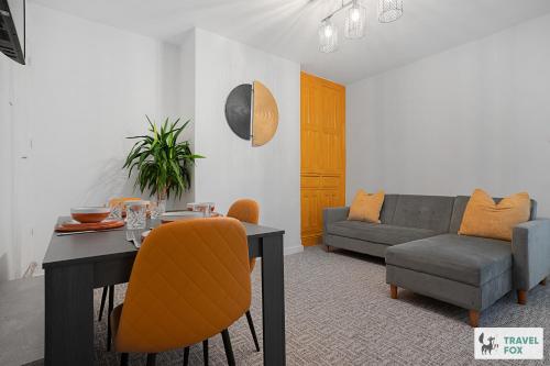 a living room with a table and a couch at Sophie's House in Nottingham