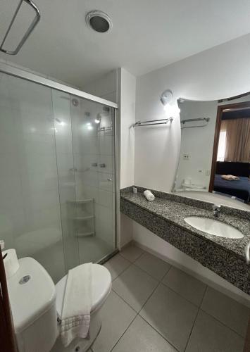 a bathroom with a toilet and a sink and a shower at Hotel Beneficência Bela Vista Com Garagem 1004 in Sao Paulo