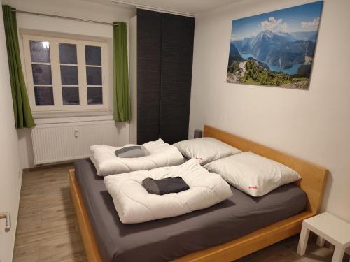 a bedroom with two beds with white pillows at FeWo Hospitalskapelle in Schwalmstadt