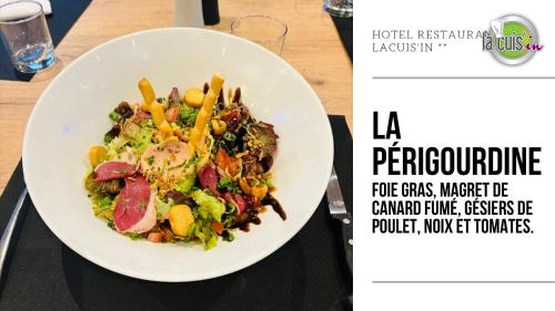 a plate of food with a salad on a table at Hotel Restaurant La Cuis'in in Coudekerque-Branche