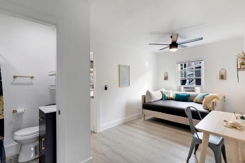 a living room with a bed and a toilet at Spacious 3br 2ba Cottage Steps to Water & Downtown in Lake Worth