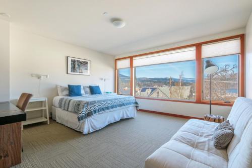 a bedroom with two beds and a large window at ALOFT Airy Design with River View in Hood River