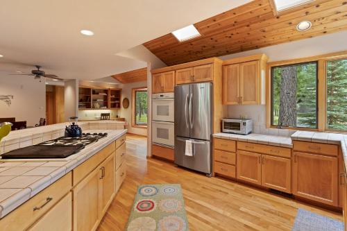 a large kitchen with wooden cabinets and stainless steel appliances at Glaze Meadow 376 in Black Butte Ranch