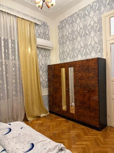 a bedroom with a bed and a dresser in it at Mehrz Globway services in Baku