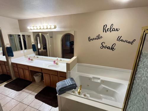 a bathroom with two sinks and a large mirror at Mesquite paradise in Mesquite