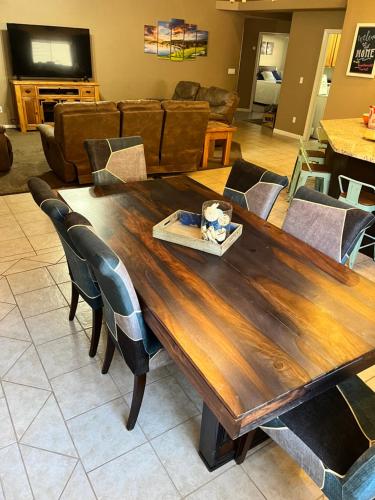 a wooden table in a living room with chairs at Mesquite paradise in Mesquite