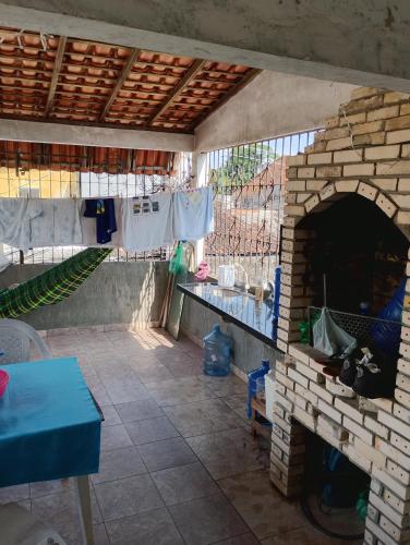 a patio with a brick oven with clothes hanging on a line at Casa nos altos in Belém