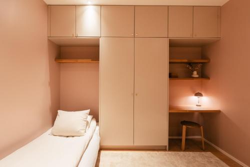 a bedroom with white cabinets and a bed at Lapland Riverside Escape in Rovaniemi