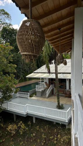 a porch of a house with a pool and a tree at Django Villa Weligama in Weligama