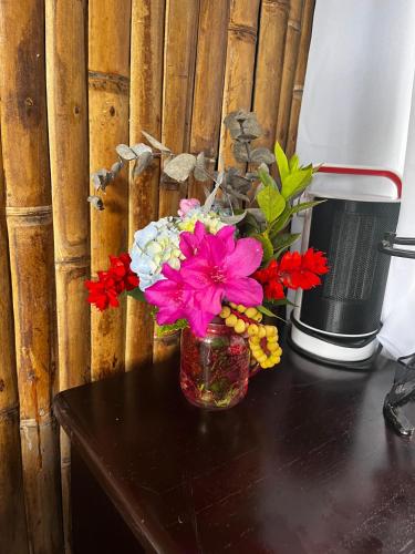 a vase filled with flowers sitting on a table at Cabinas los Jilgueros in San Vito