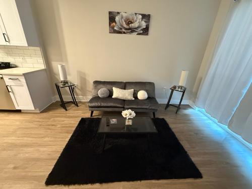 a living room with a couch and a table at Modern & Spacious Stay in Prime Location Parking in Richmond