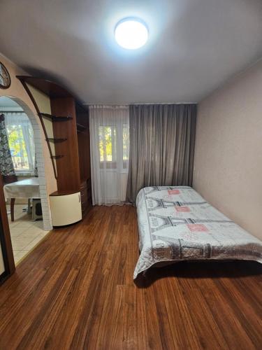 a bedroom with a bed and a staircase in it at Апартаменты на Новых Домах in Kharkiv