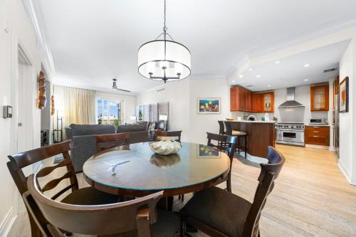 a dining room and living room with a table and chairs at Beach Residences On Siesta, aka The Hyatt in Siesta Key