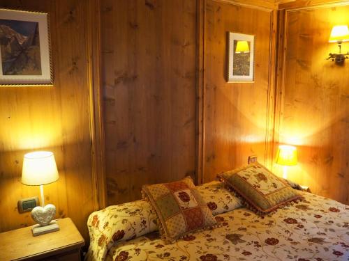a bedroom with a bed with two pillows on it at Courmayeur Cozy Nest in Courmayeur