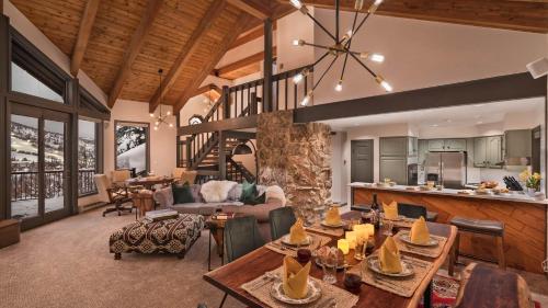a large living room with tables and a kitchen at Glacier Lodge - East in Steamboat Springs