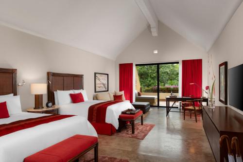 a hotel room with two beds and a desk at Grand Velas Riviera Maya - All Inclusive in Playa del Carmen