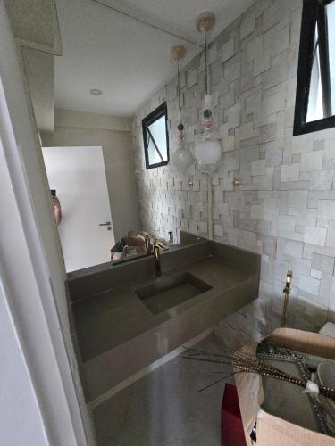 a bathroom with a sink and a counter top at High standard apartment for the COP30 in Belém