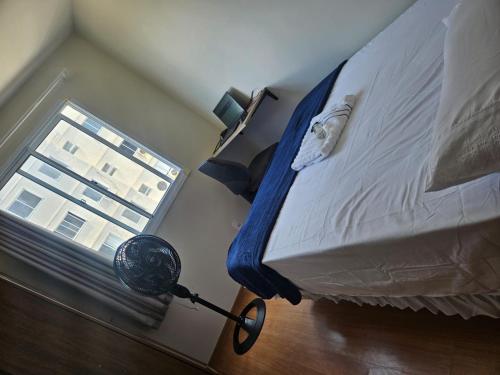 a bedroom with a large bed with a window at Ap da Familia - SLZ in São Luís