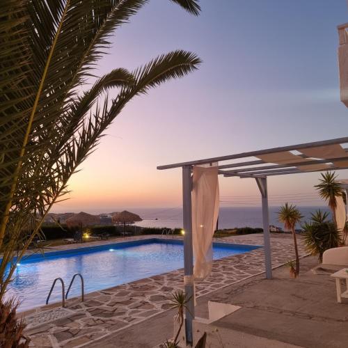 a view of a swimming pool at dusk at Bellevue Village ''Αdults Only'' in Agia Pelagia