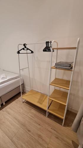 a room with a shelf next to a bed at Deichliebe 3 - gemütlich, zentral und modern- Inklusive privater Stellplatz im Parkhaus 2min zu Fuß entfernt in Bremerhaven