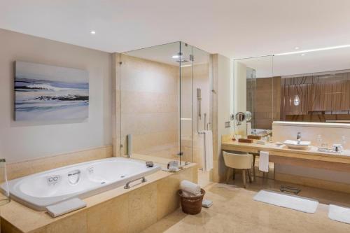 a bathroom with a tub and a sink and a shower at Grand Velas Riviera Maya - All Inclusive in Playa del Carmen
