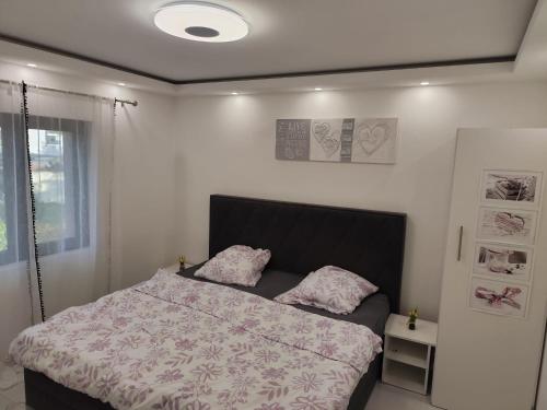 a bedroom with a bed with two pillows on it at Appartement meublé Rixheim Alsace in Rixheim