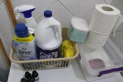 a shelf with a basket with milk and other kitchen items at TopView Apartment In front of Saranda Port in Sarandë