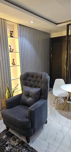 a blue couch sitting in a room with a table at Ladi's place Anthony Ikeja in Lagos