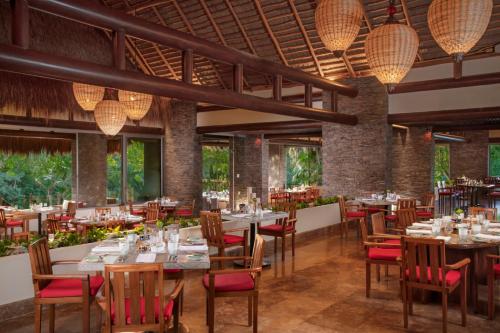 a restaurant with tables and chairs and lights at Grand Velas Riviera Maya - All Inclusive in Playa del Carmen