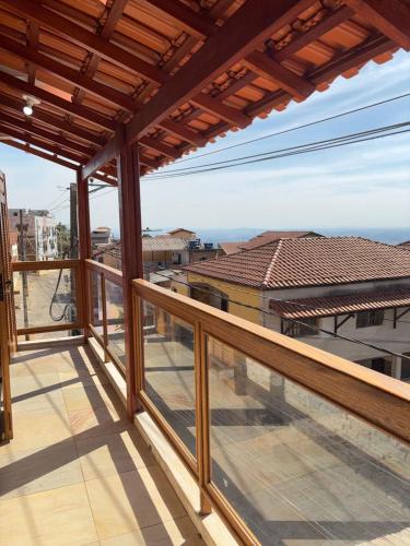 a balcony with a view of the ocean at Pousada do Cid in São Thomé das Letras